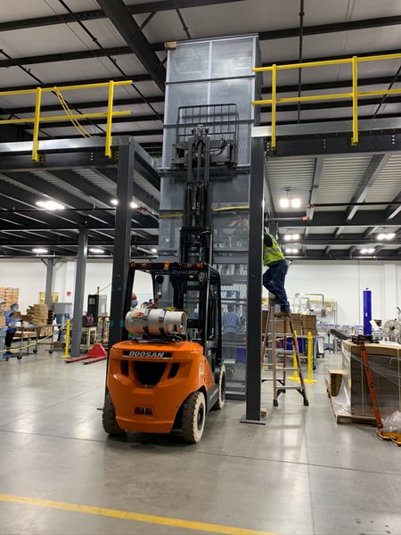 mezzanine conveyor construction using electric forklift